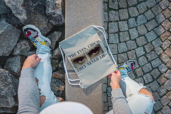 DRAW STRING BAG – EYES NEVER LIE – 13×18 inches